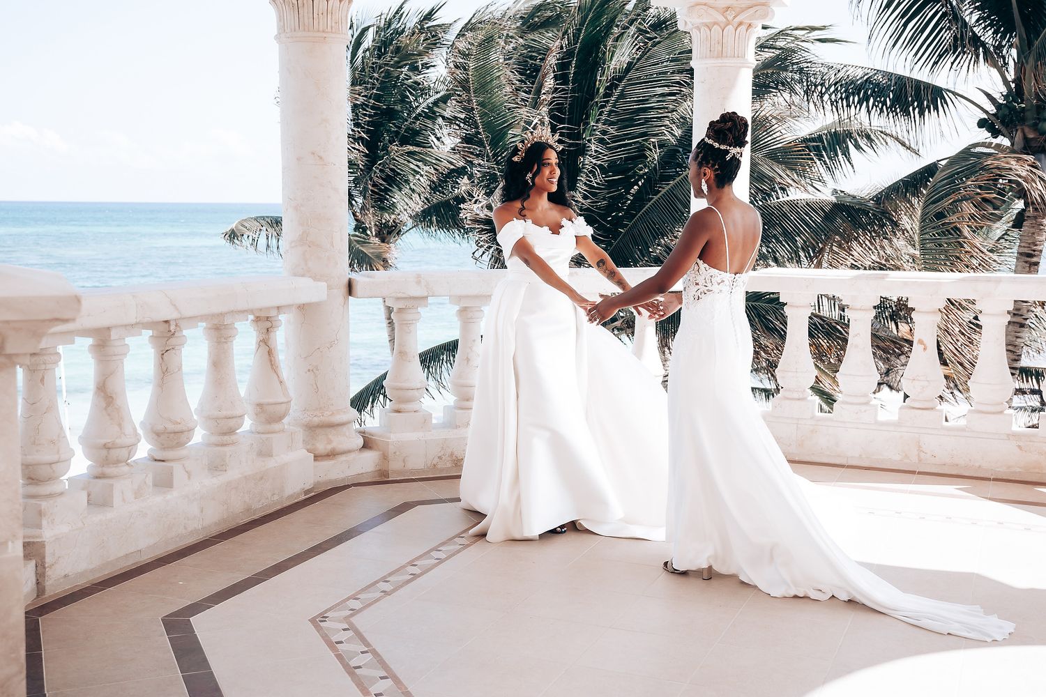 Elegant white balcony overlooking a tropical beach with palm trees and ocean views.