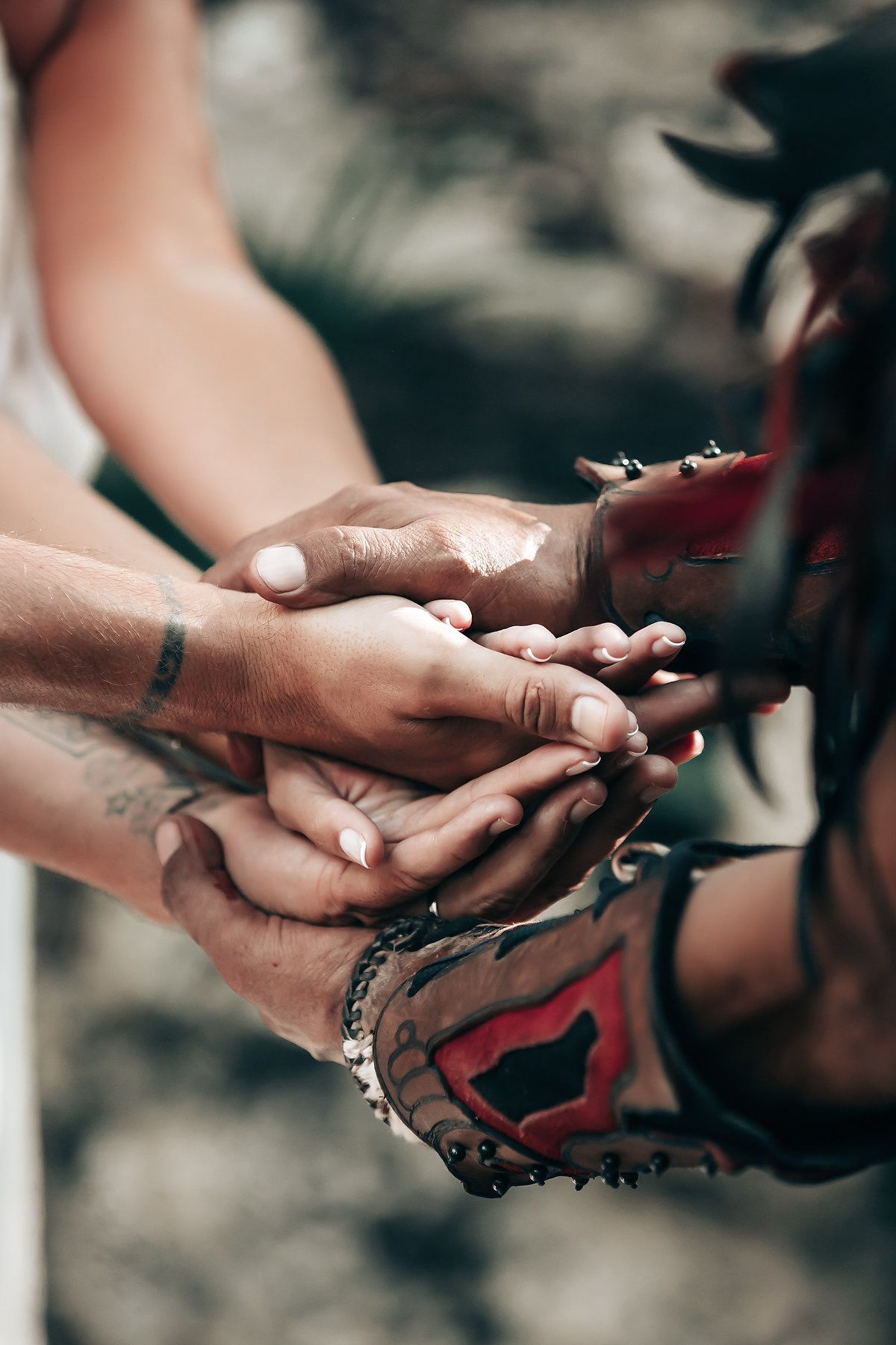 Hands of two people clasped together in a gesture of unity or connection.
