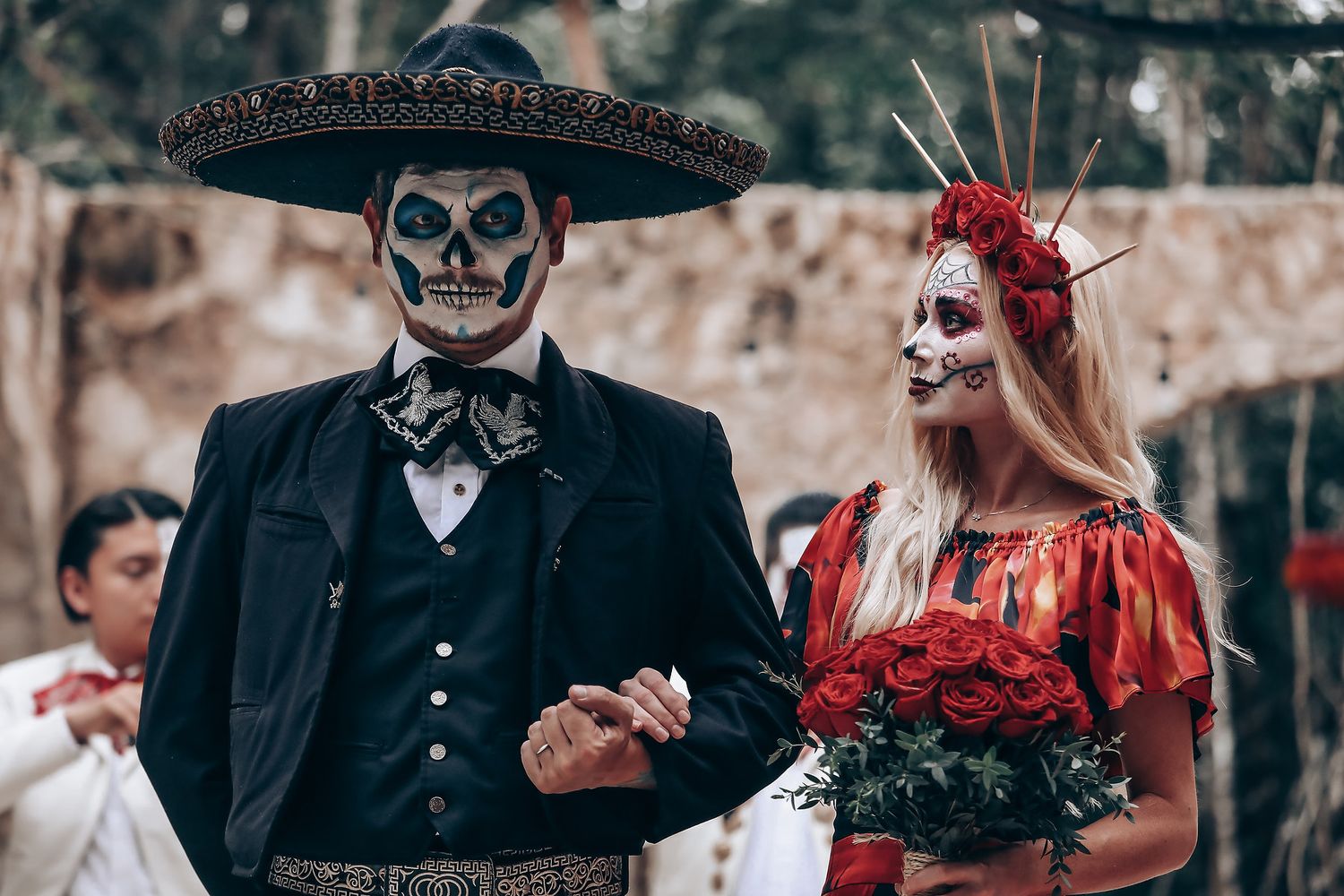 Day of the Dead themed wedding photoshoot with sugar skull makeup and traditional Mexican attire.