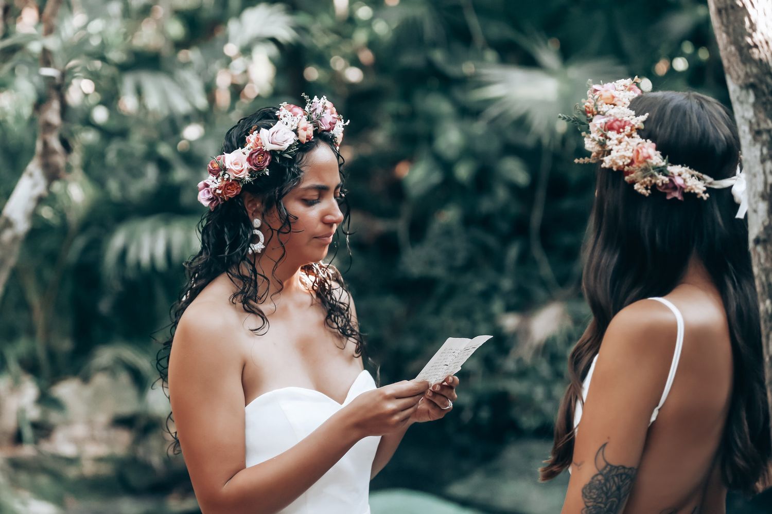 A wedding couple shares intimate moments in a lush tropical garden setting.