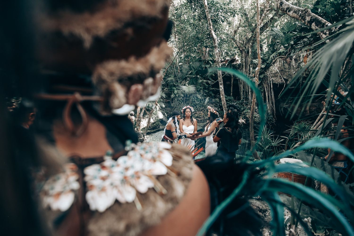 A moody forest setting with flowering branches and natural elements creating an ethereal atmosphere.
