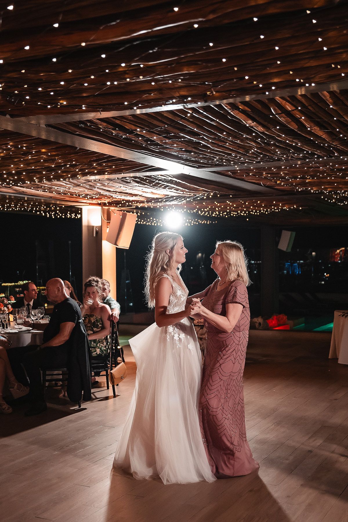 Wedding reception venue with twinkling lights on the ceiling creates a magical atmosphere.