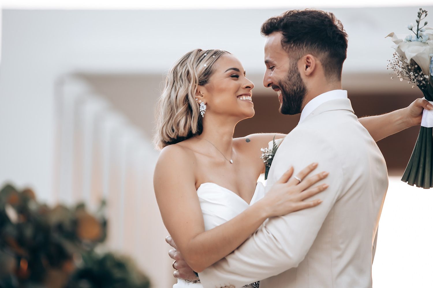 Couple sharing romantic dance moment at outdoor wedding reception.