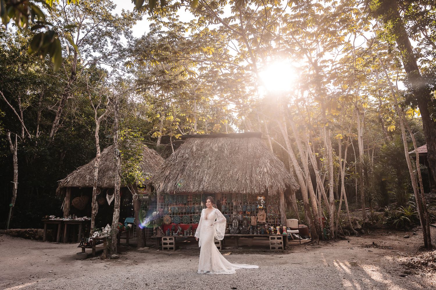 A rustic outdoor wedding ceremony venue with wooden benches and natural sunlight filtering through the trees.