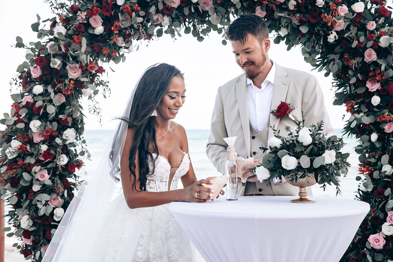 Romantic wedding setup with pink and white floral arch decorations.
