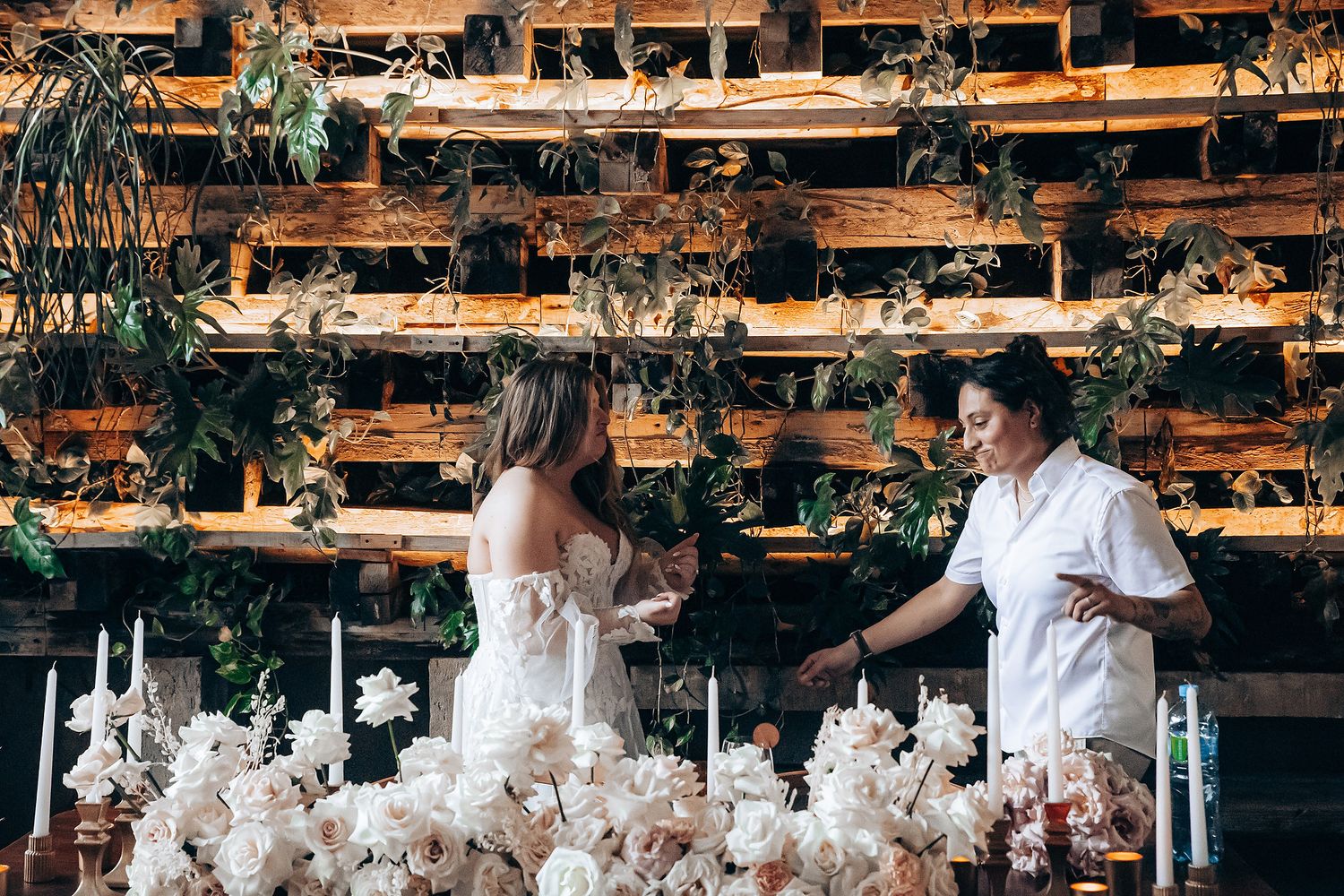 Reception space decorated with hanging floral arrangements and rustic wooden details.