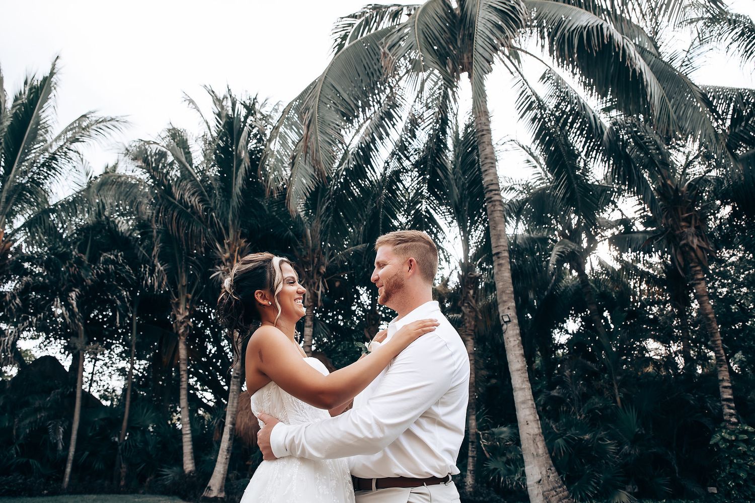 Palm trees frame a tropical wedding venue setting.