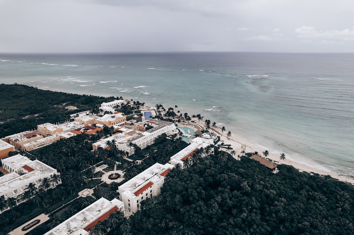 Aerial view of a coastal resort wedding venue with ocean and beach landscapes.