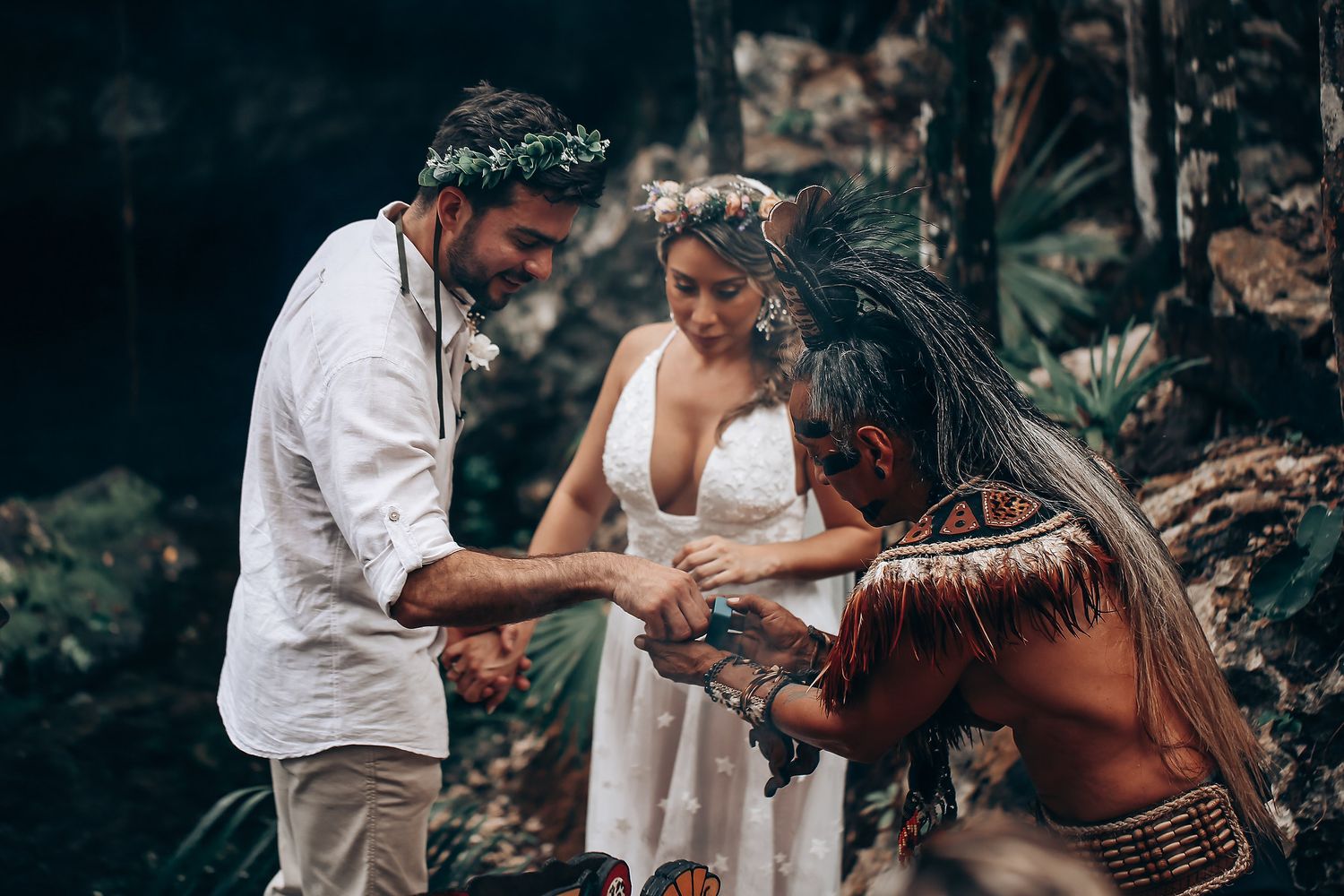 A traditional ceremony unfolds in a forest setting with indigenous cultural elements.