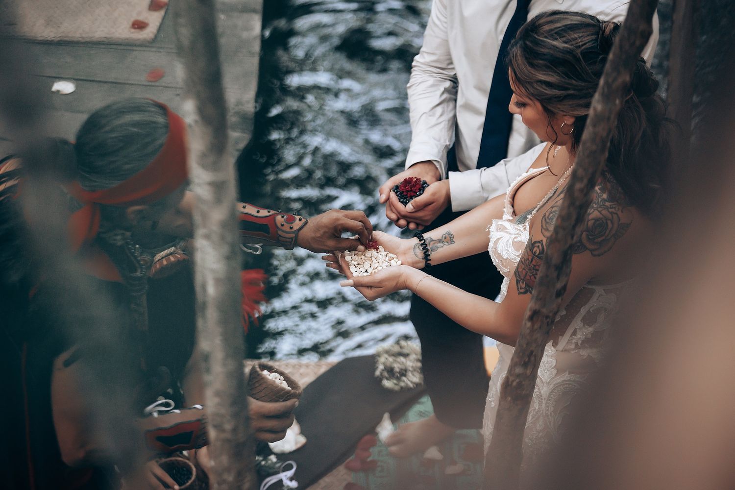 Close-up shot of a traditional handfasting ritual being performed during an outdoor ceremony.