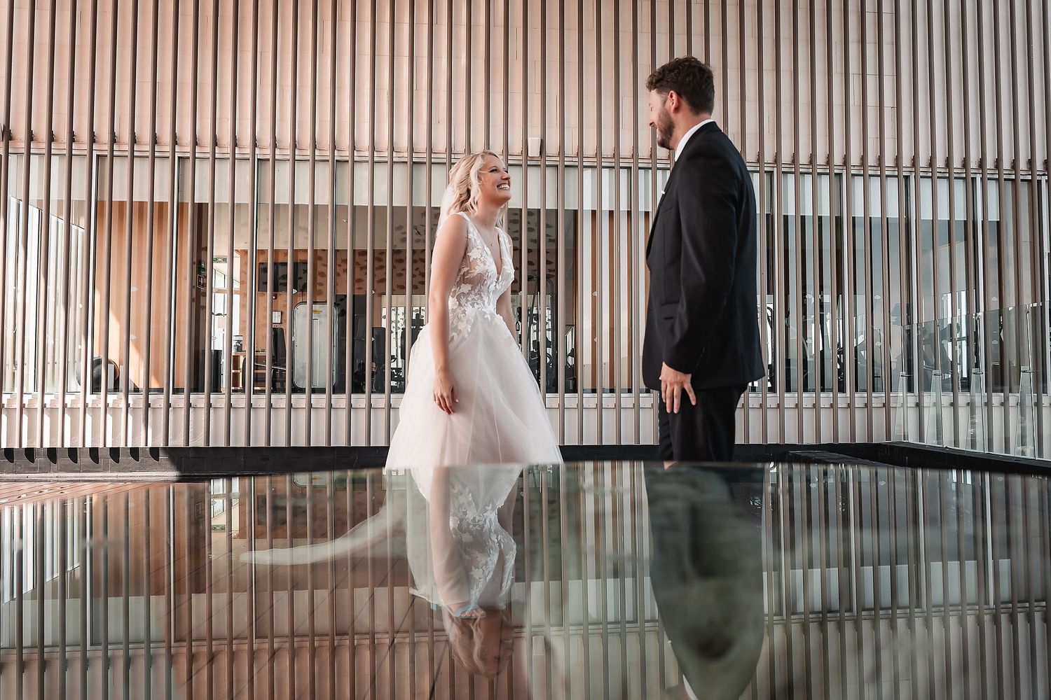 Artistic sequence of a couple's first look moment in a modern architectural setting.