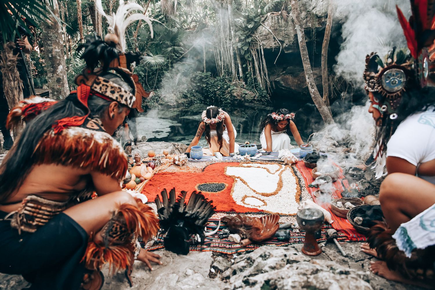 Cultural celebration in a forest clearing with traditional decorations and gatherings.