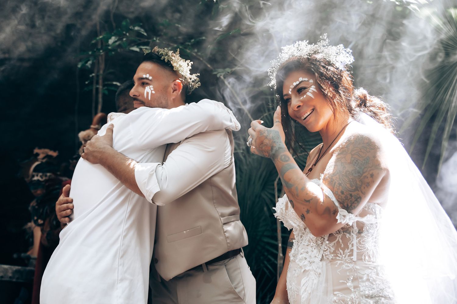 Romantic embrace captured during wedding celebration with atmospheric lighting.