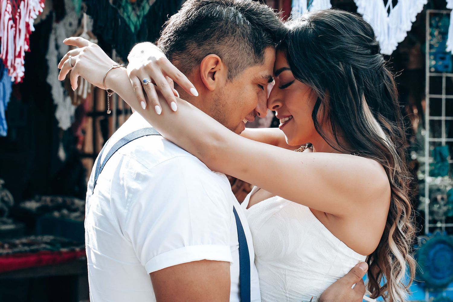 A romantic wedding photo collage showing couples embracing and dancing in formal attire at an elegant venue.