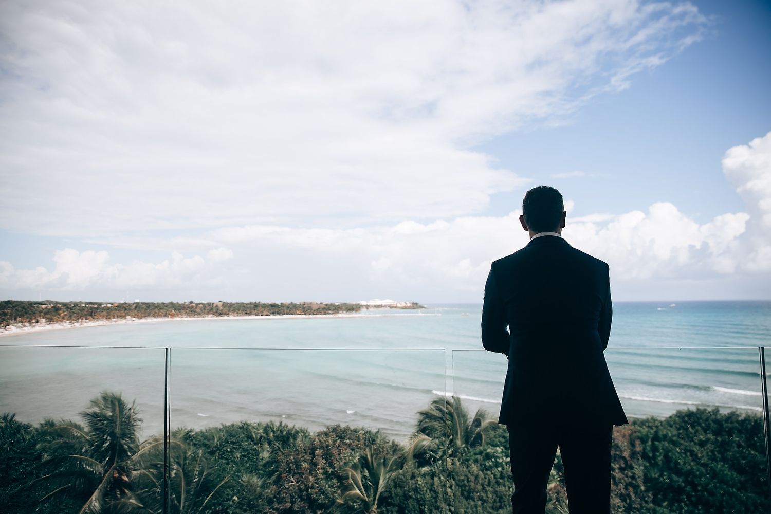 Scenic beach landscape views with palm trees and ocean waves under blue skies.