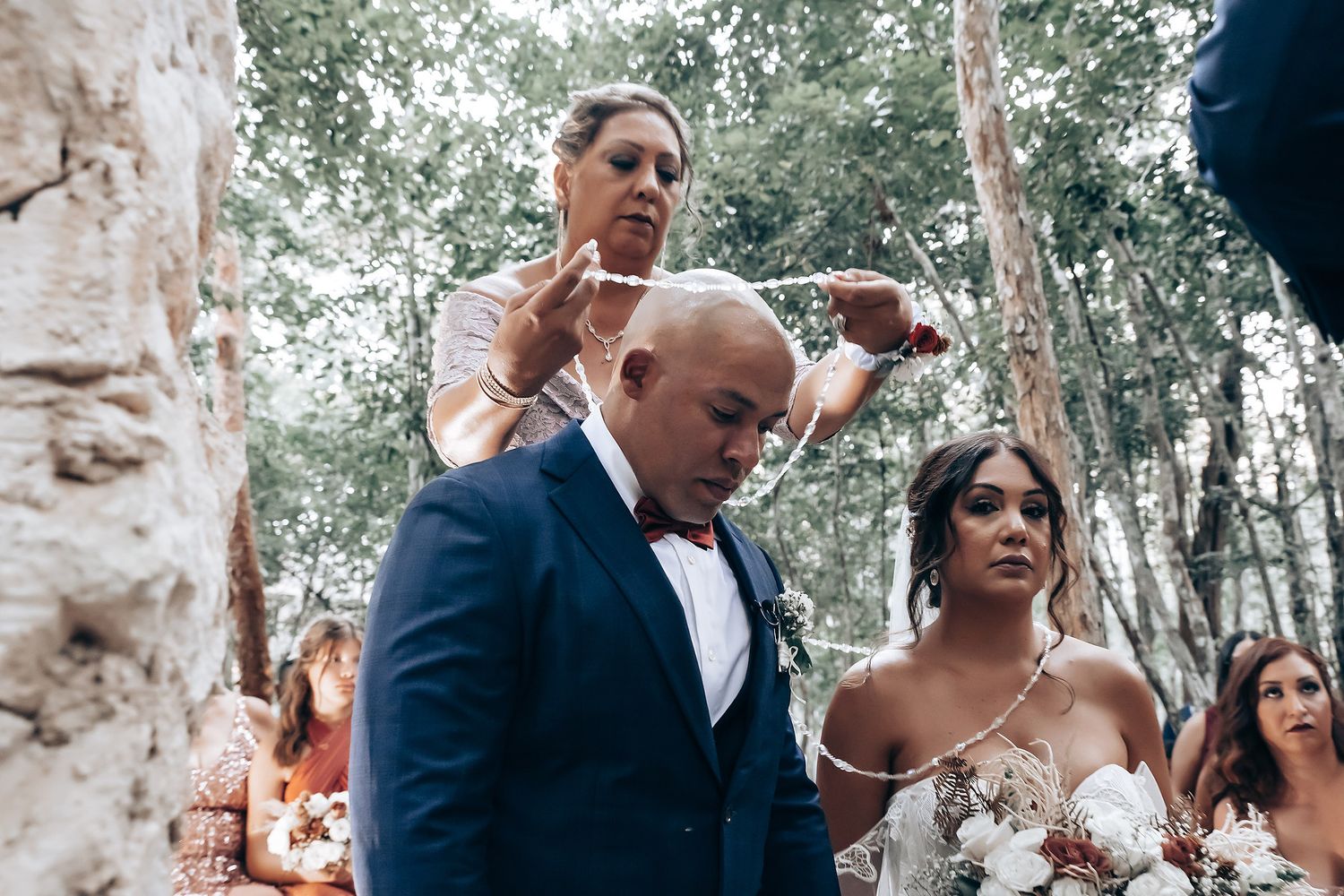A couple shares a tender moment during their outdoor wedding ceremony.
