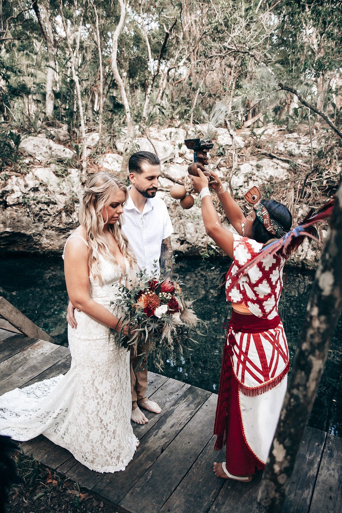 A traditional Mayan ceremony takes place on a wooden platform overlooking a cenote in Mexico.
