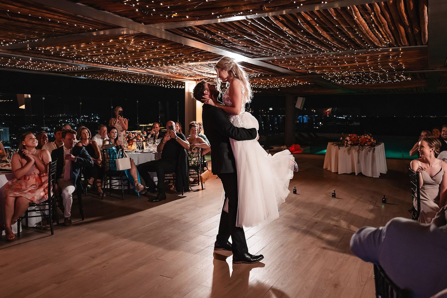 Wedding reception venue decorated with twinkling string lights creating a romantic atmosphere.