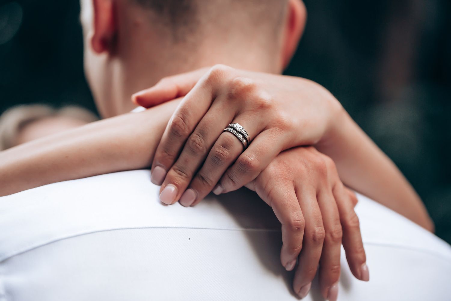 Close-up shot of hands gently touching in soft natural light.
