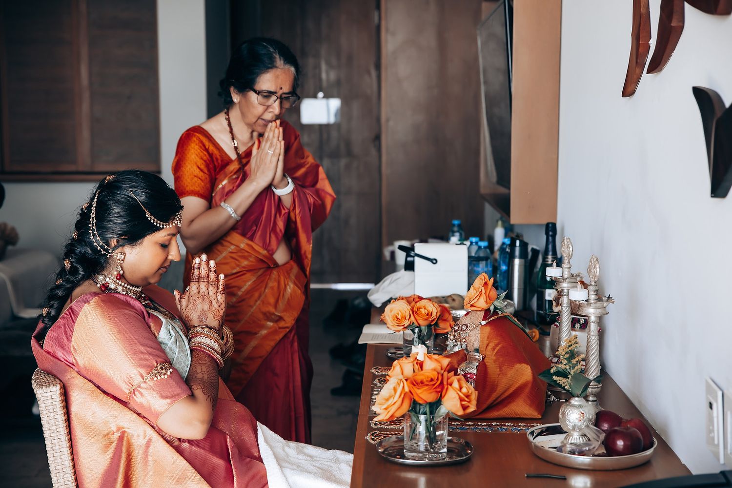 Traditional Indian prayer ceremony setup with orange flowers and offerings.