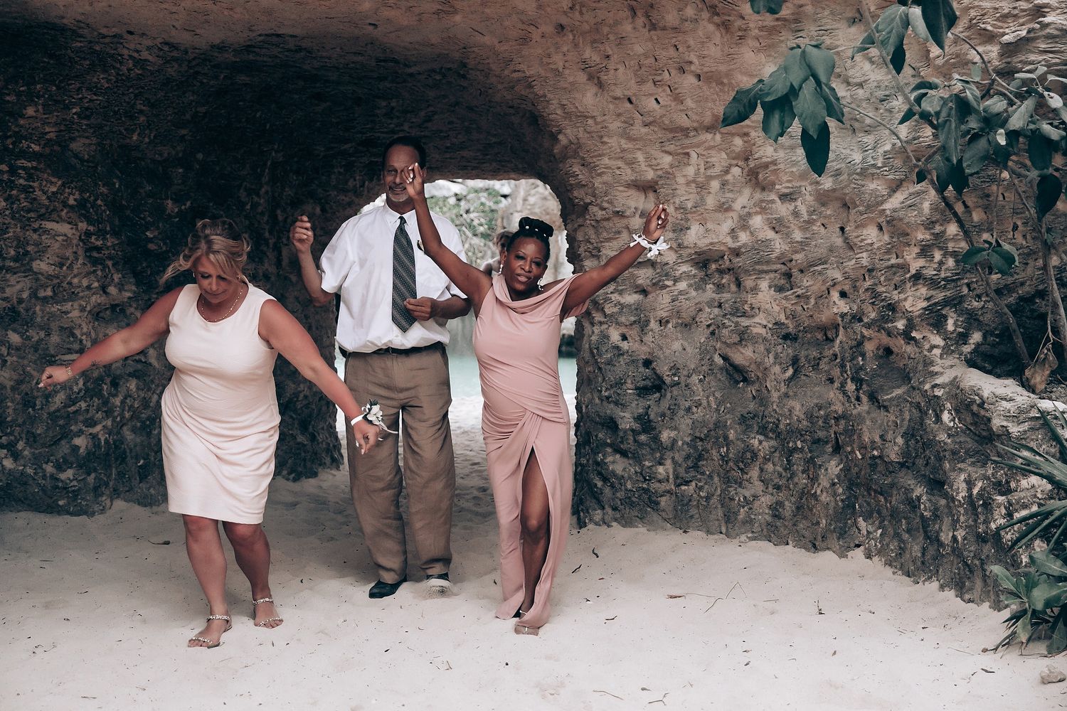 Wedding guests dancing and celebrating in a rustic outdoor venue.