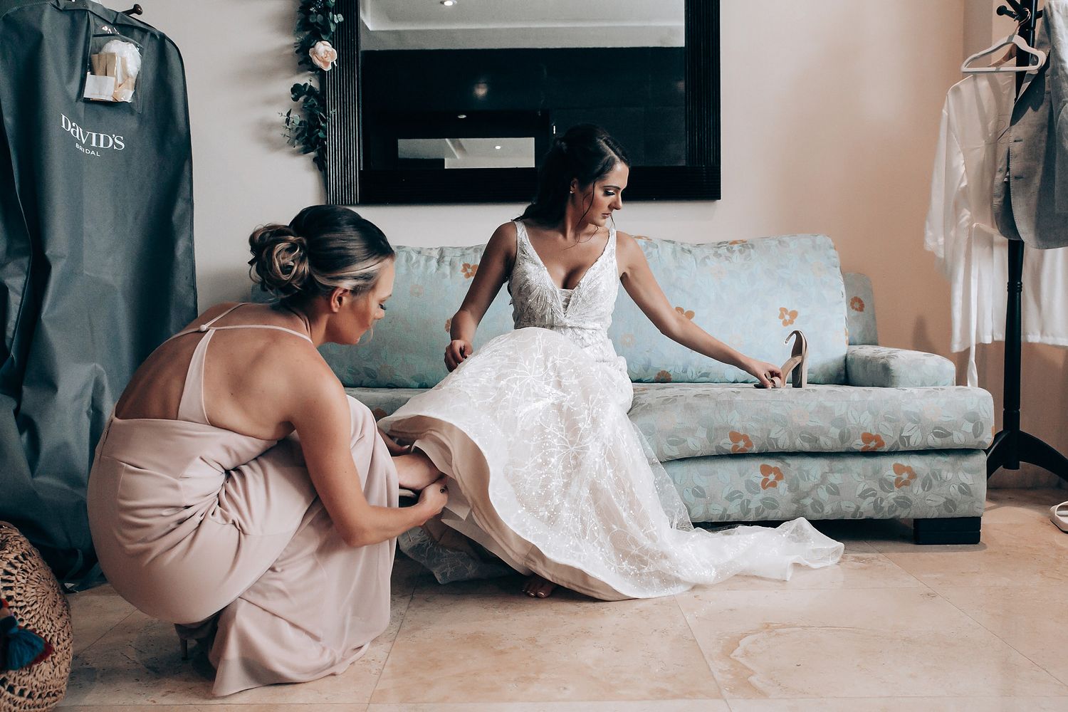 A sequence of images showing someone carefully arranging and preparing a white wedding dress on the floor.