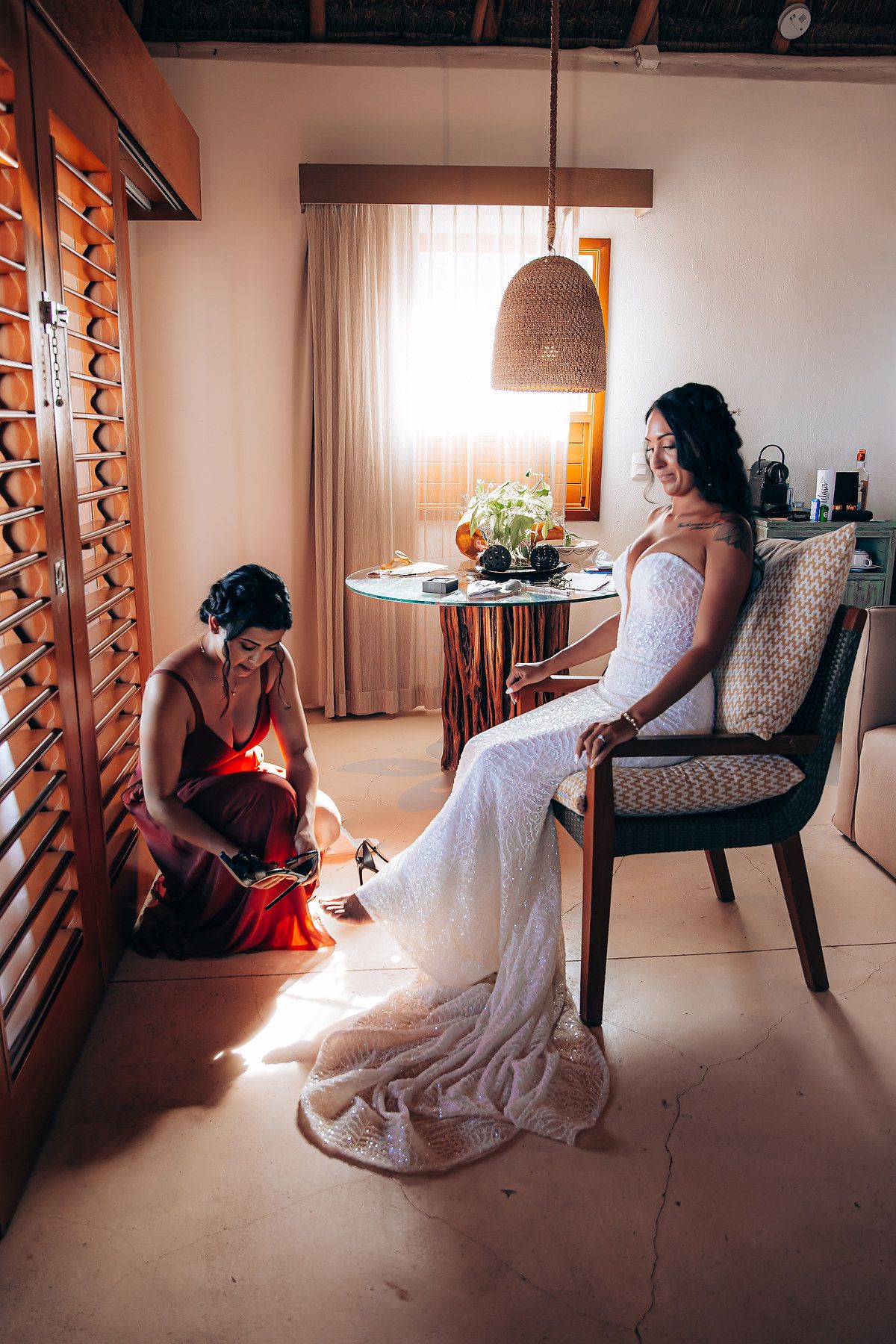 Wedding preparation scene in a room with dramatic lighting and wooden shutters.
