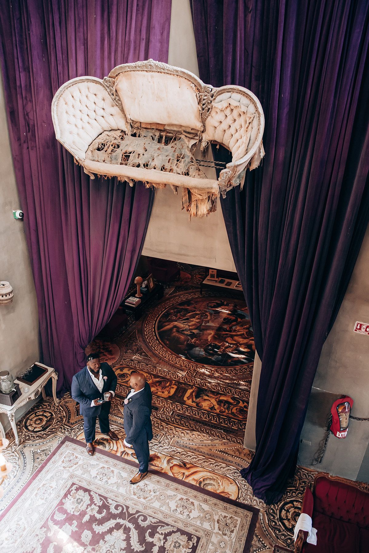 Four sequential photos show the installation process of an ornate antique bed with purple curtains and patterned bedding.