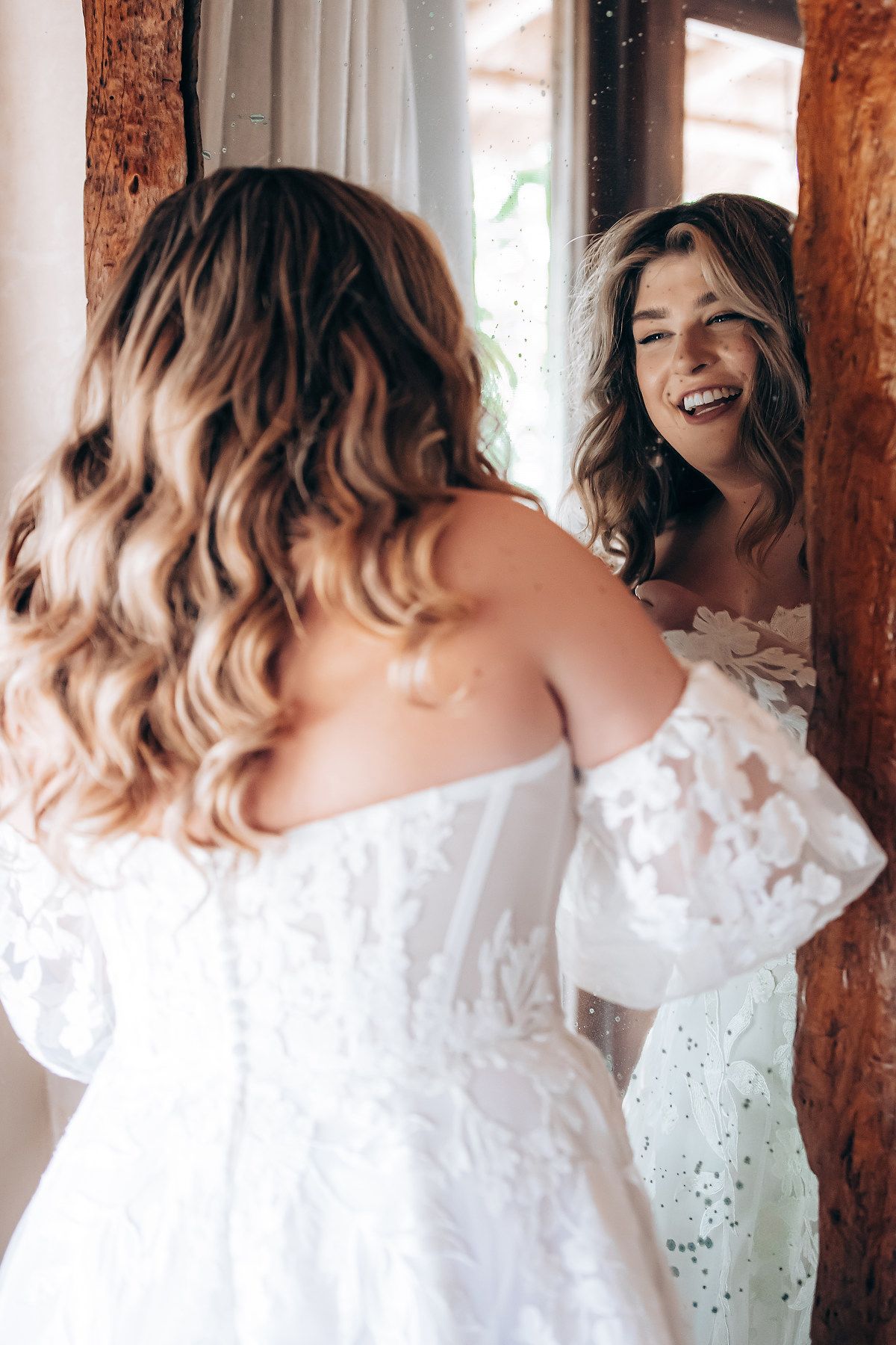 A sequence of photos showing someone in a white lace dress spinning and laughing against a rustic wooden background.