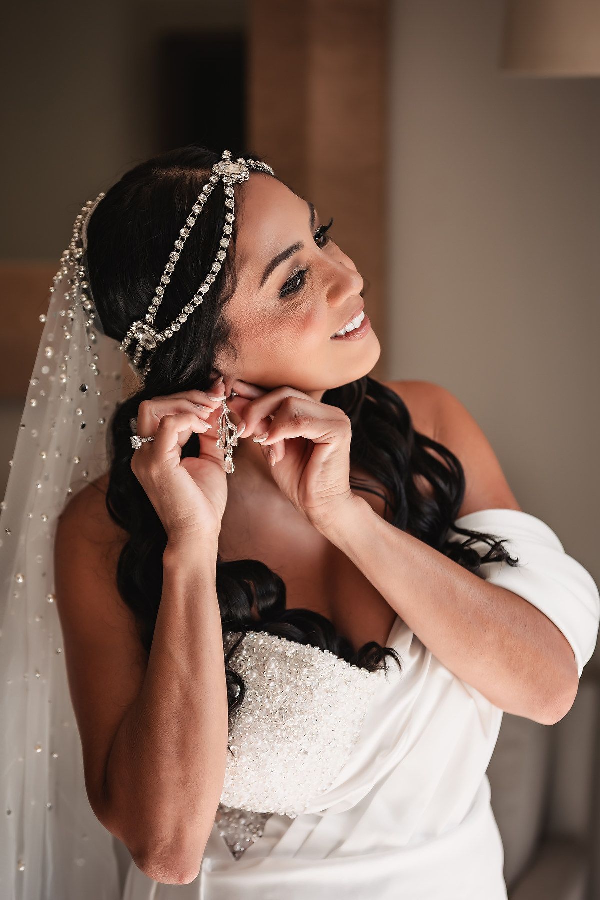 Close-up shots of pearl-adorned bridal veil being adjusted in natural light.