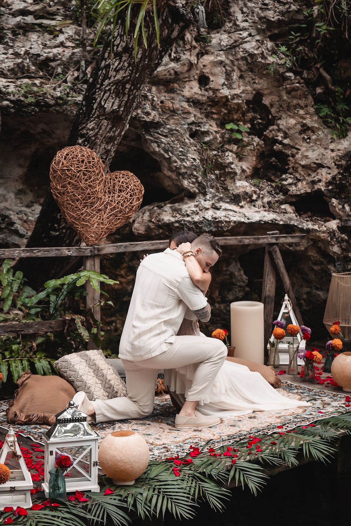Proposal scene with decorative heart and lanterns against rocky cave wall.