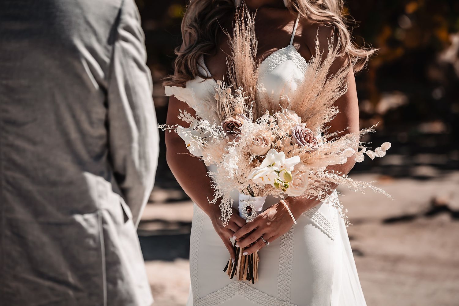 Close-up details of a delicate dried flower bouquet with soft pink and white blooms.