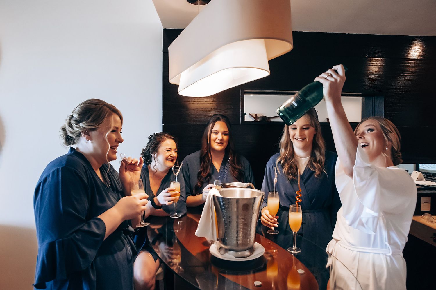 A group of friends enjoying drinks and conversation at a bar or restaurant.