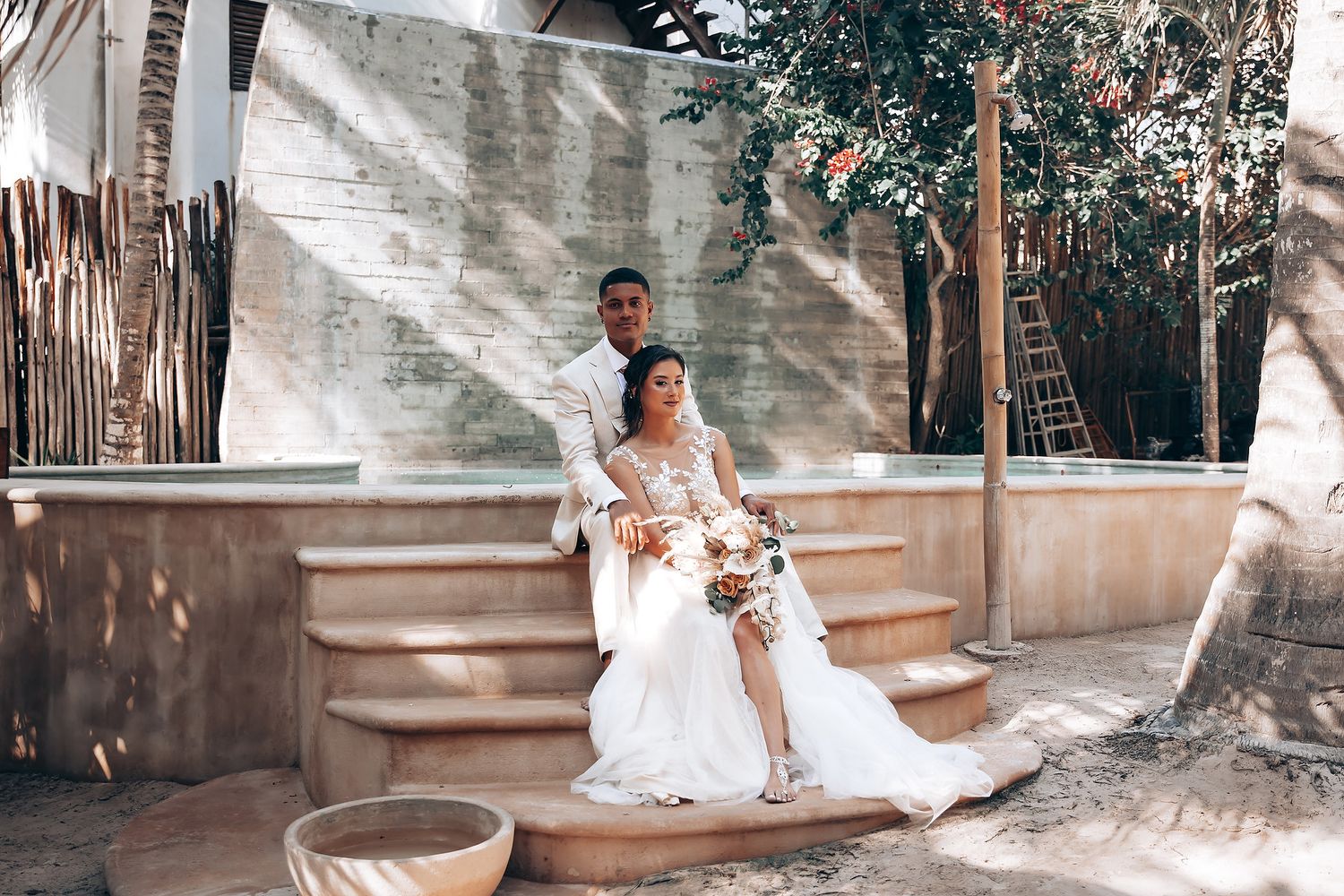 A romantic outdoor wedding ceremony setup with white chairs and floral decorations.