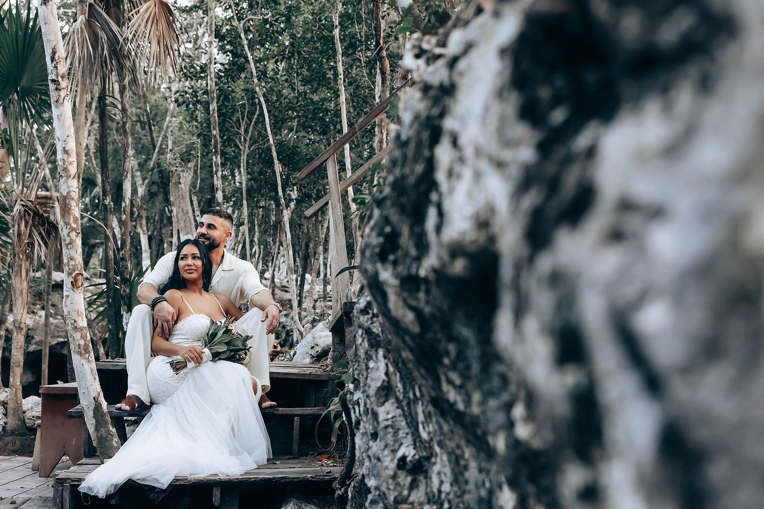 Elegant outdoor wedding photography session among tall eucalyptus trees.