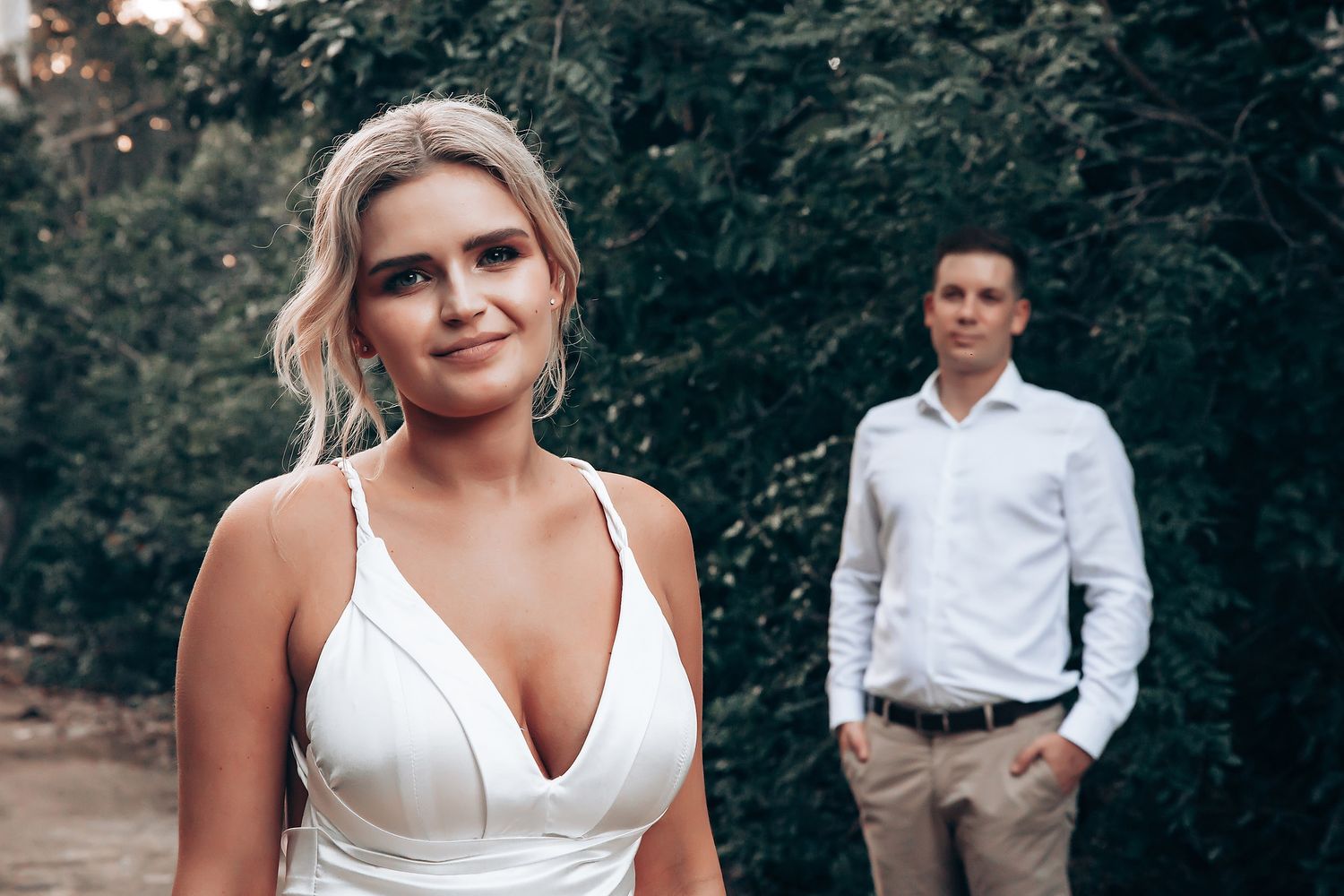 Wedding celebration in a natural forest setting with white attire.