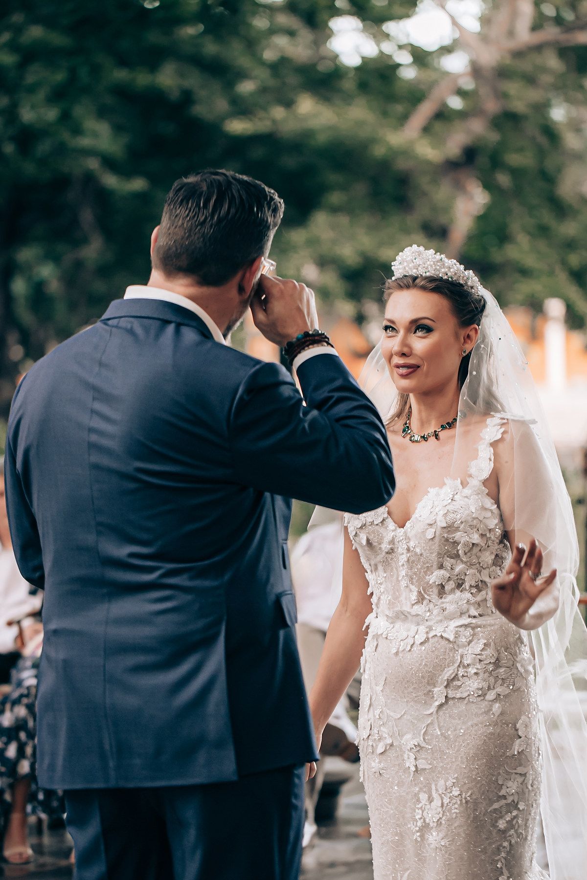 A sequence of wedding photos showing tender moments between a couple during their outdoor ceremony.