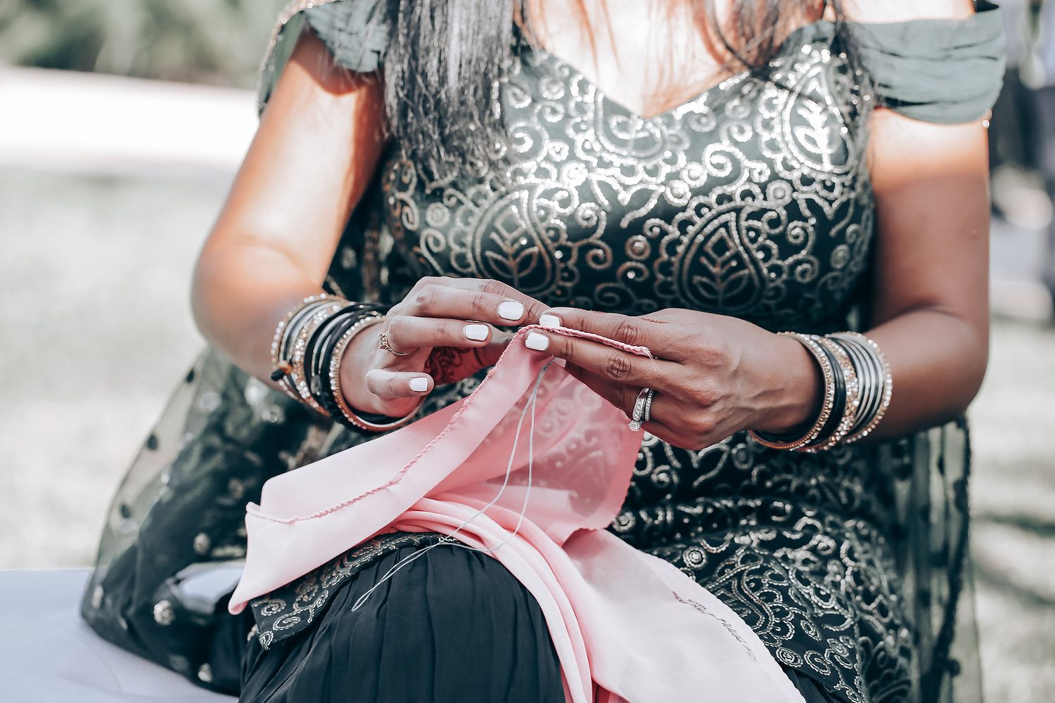 Detail shots of formal attire and jewelry at an elegant wedding reception.