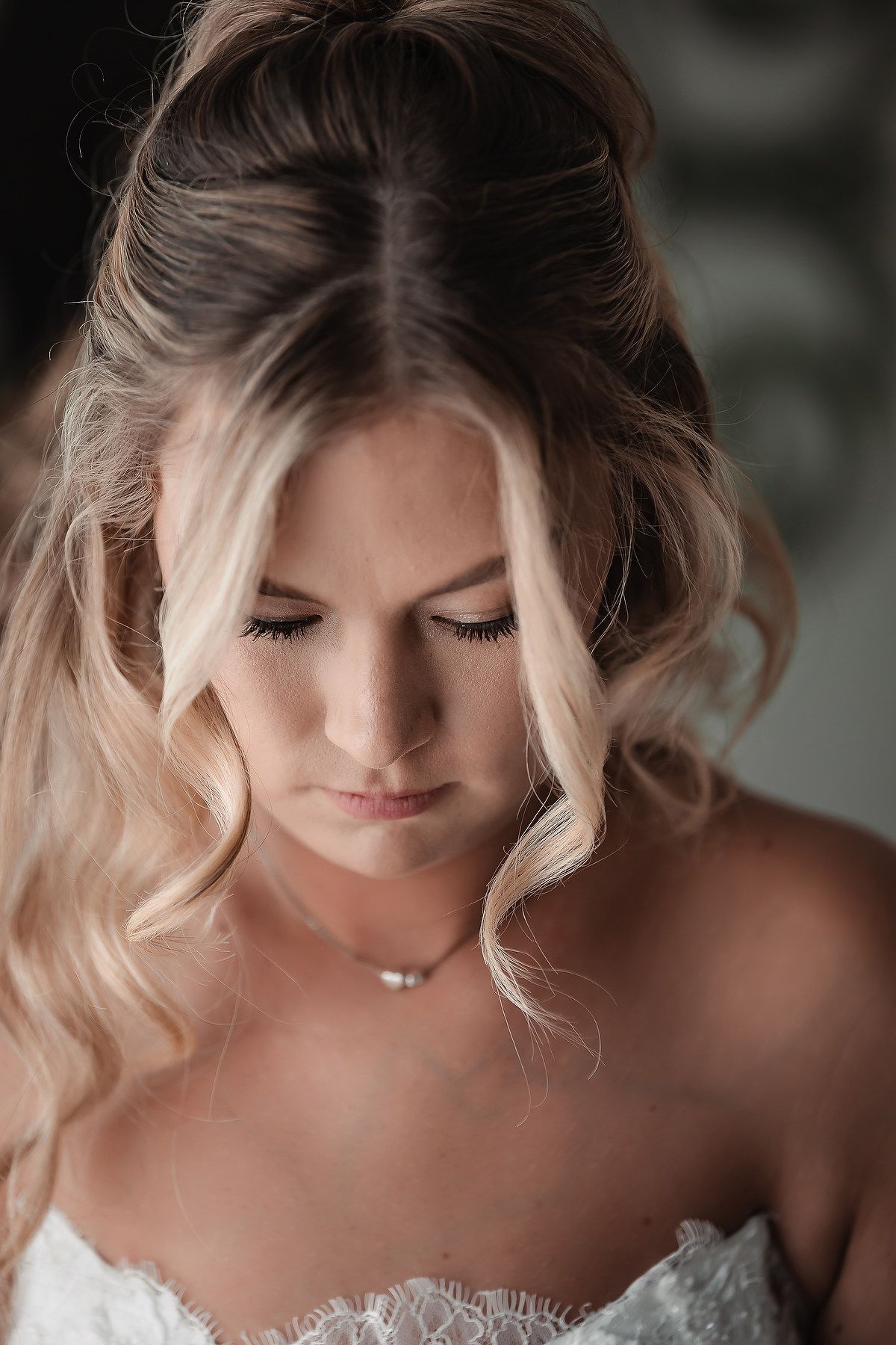 Close up of bride with soft wavy blonde hair and natural makeup.