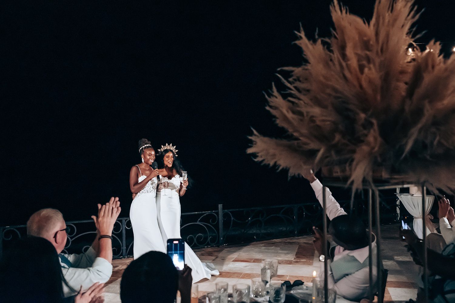Wedding celebration at dusk with dried pampas grass decorations.