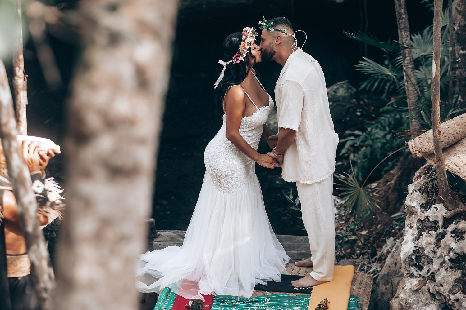 Wedding guests celebrate in an outdoor forest setting with smoke effects and festive atmosphere.