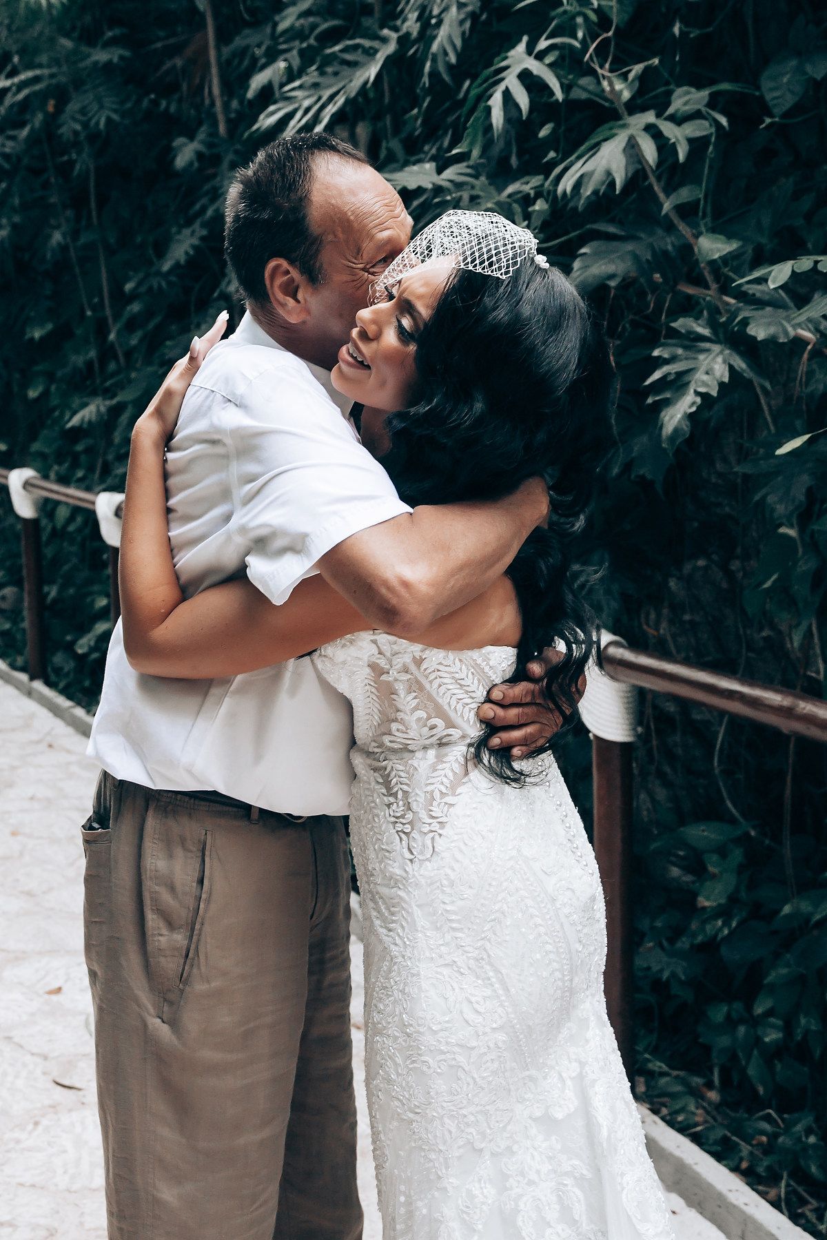 A tender embrace between newlyweds at an outdoor wedding ceremony.