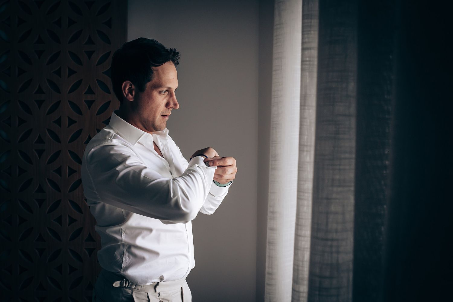 A person in a white karate uniform performs a martial arts sequence against a dark background.