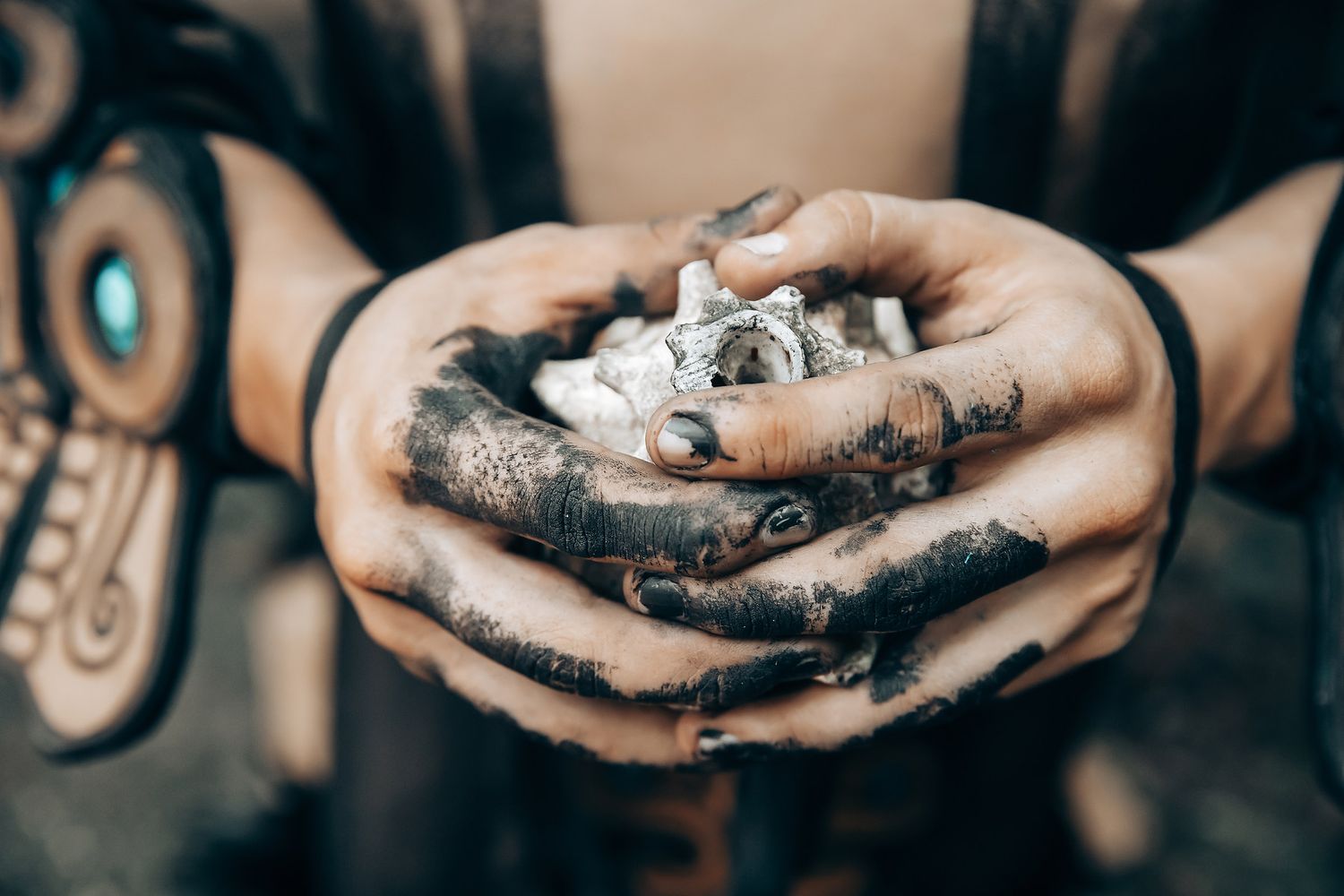 Close-up shot of hands holding small ceremonial items during a wedding ritual.