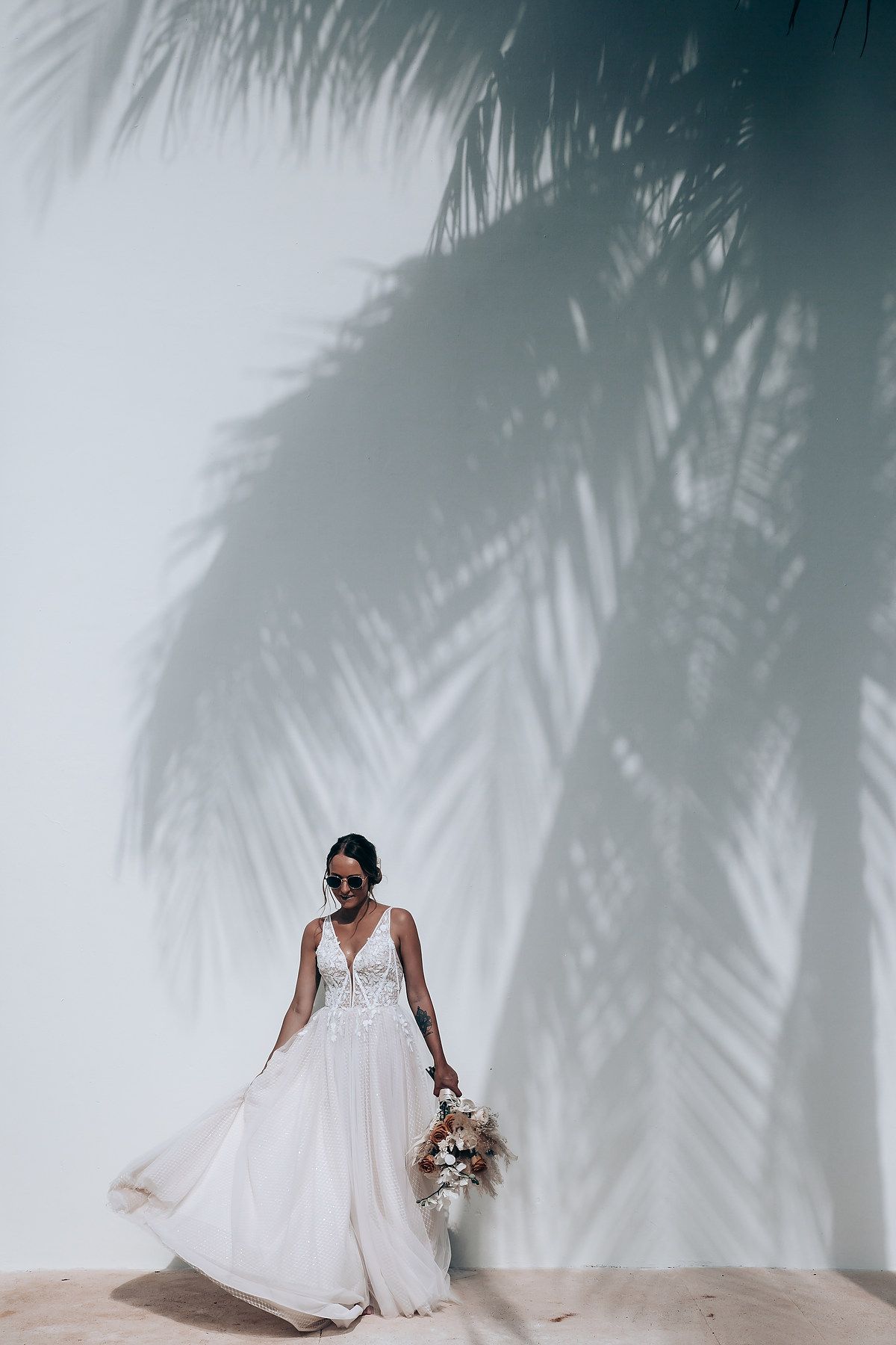 Artistic bridal portraits with palm tree shadows creating dramatic lighting effects.