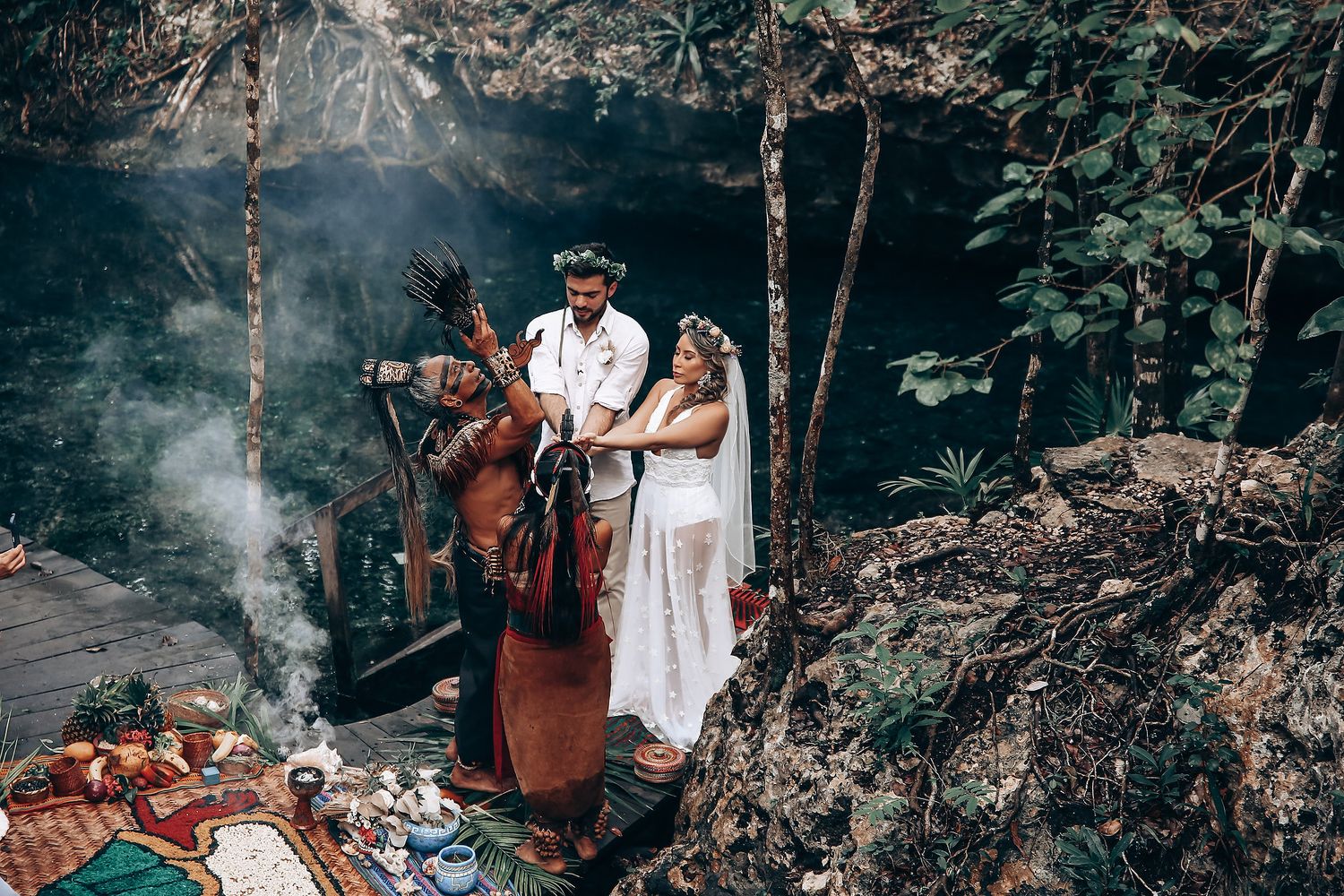 A mystical forest wedding ceremony with smoke and natural lighting creating an ethereal atmosphere.