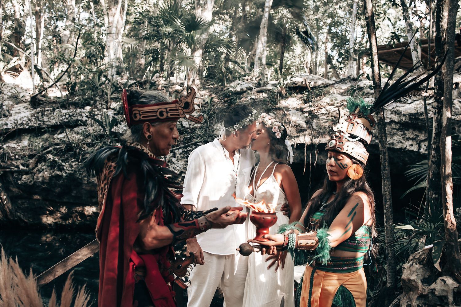 A group of people engage in a traditional ceremony or ritual in a natural setting.
