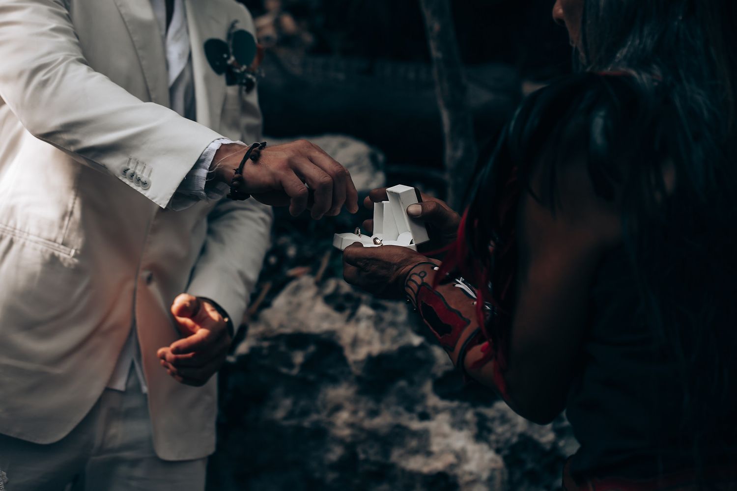 A close-up shot of hands pouring a beverage into glasses at a celebration.