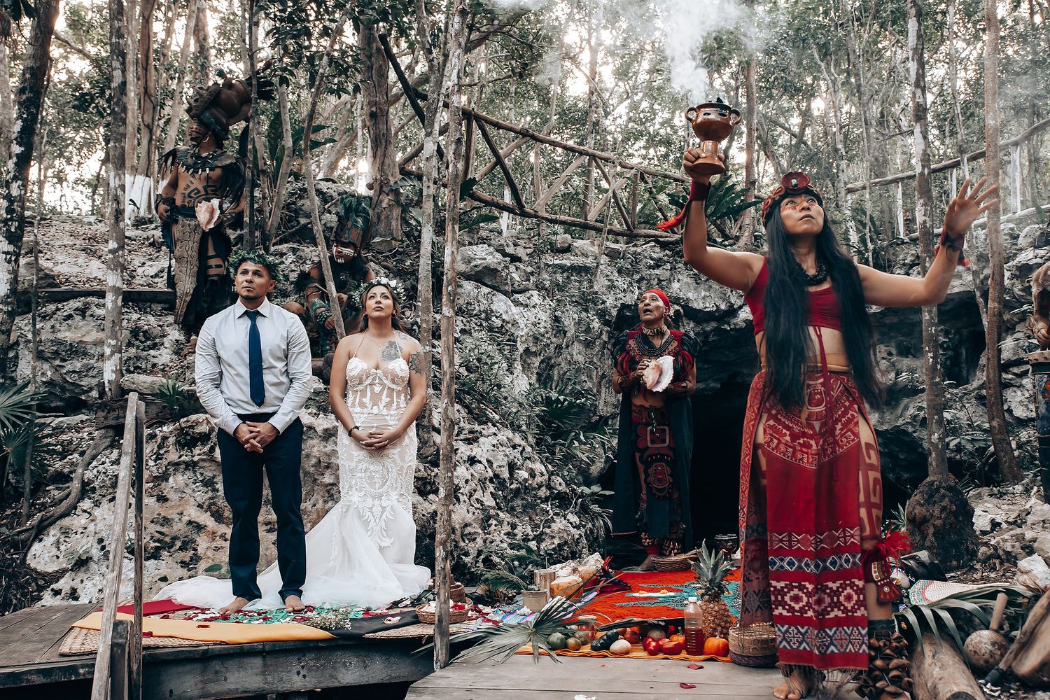 Panoramic view of wedding guests enjoying an outdoor celebration among eucalyptus trees.