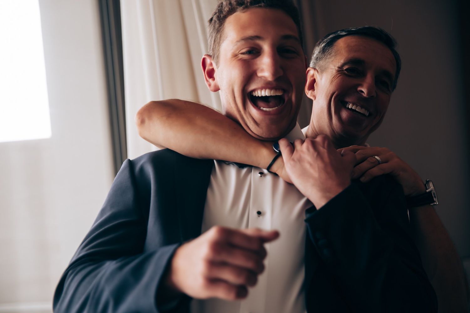 Two people laughing together in a series of candid black and white photos.